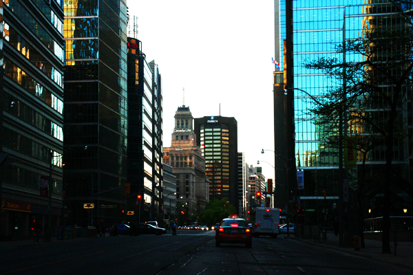 The sun setting on the concrete and glass jungle of Toronto