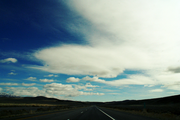 Blue skies and clouds over an open road